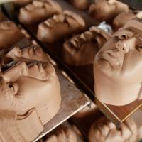 Masks of U.S. Republican presidential candidate Donald Trump are seen drying on shelves at Jinhua Partytime Latex Art and Crafts Factory in Jinhua, China, on Wednesday. | REUTERS