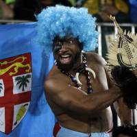 A Fiji fan celebrates his country\'s gold medal victory over Britain in the men\'s rugby sevens at the 2016 Summer Olympics in Rio de Janeiro on Thursday. | AP