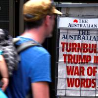 A pedestrian looks at a newspaper headline about U.S. President Donald Trump and Australian Prime Minister Malcolm Turnbull in central Sydney on Friday. | REUTERS