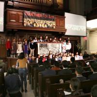 A choir performs a song for a memorial service Sunday at a church in New York to pray for the victims of the Great East Japan Earthquake of March 11, 2011. | KYODO