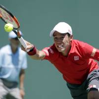 Kei Nishikori reaches to play a shot against Federico Delbonis at the Miami Open on Tuesday. | AP