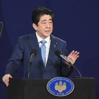 Prime Minister Shinzo Abe attends a news conference in London on Saturday. | KYODO