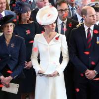 British Prime Minister Theresa May (left) and Prince William and Catherine, the Duke and Duchess of Cambridge, watch as poppies fall from the roof of the Menin Gate in Ypres, Belgium, on Sunday during the official commemorations marking the 100th anniversary of the Battle of Passchendaele. | REUTERS
