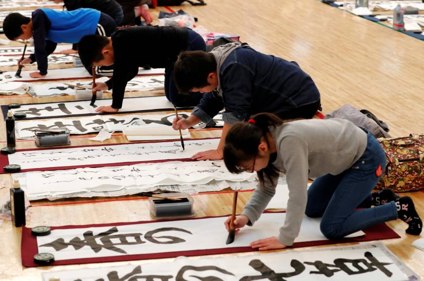 Students participate in a New Year calligraphy contest in Tokyo, Japan, January 5, 2018. REUTERS/Kim Kyung-Hoon