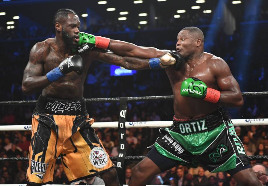 Deontay Wilder survives pummeling to retain title against ...