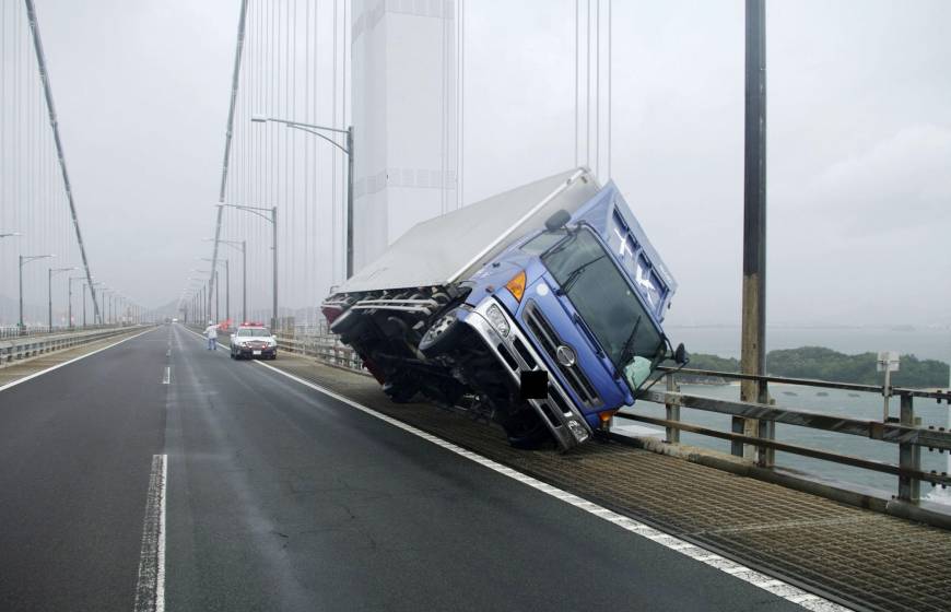 Strong winds from Typhoon Jebi blew this truck over as it crossed the Seto Ohashi Bridge in Sakaide, Kagawa Prefecture, on Tuesday.