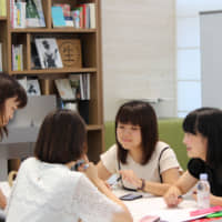 High school students speak with a Shiseido Co. employee as part of the workshop.