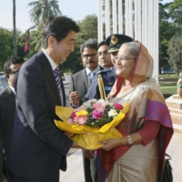 Bangladeshi Prime Minister Sheikh Hasina welcomes Abe in Dhaka during a September 2014 visit. | KYODO