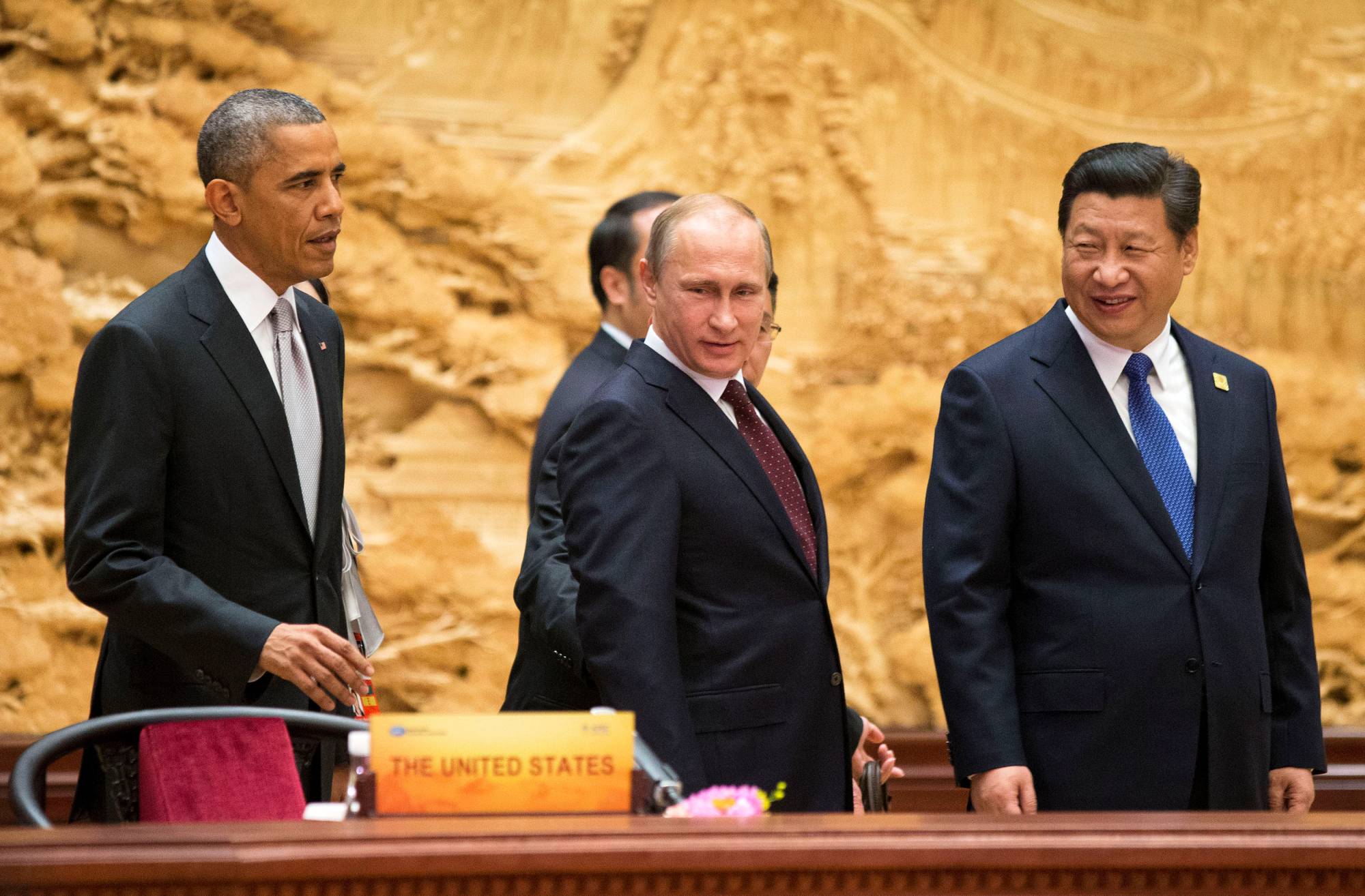 Chinese President Xi Jinping and his American and Russian counterparts, President Barack Obama (left) and Vladimir Putin (center), attend the Asia Pacific Economic Cooperation Summit plenary session in Beijing in November 2014. | POOL / VIA REUTERS