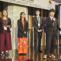 Shane Ubana (left) attends the TASC Action Plan Final Presentation on Nov. 24 in Tokyo. | KENICHI AIKAWA
