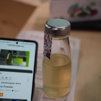 'Green Sake (using Euglena cultured yeast extract)' as part of a demonstration of sake providing experiences using NFC technology.