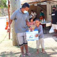 Residents pick up emergency supplies after the deadly Hunga Tonga-Hunga Ha’apai volcano erupted in 2022, spawning tsunami that caused heavy damage in Tonga. | EMBASSY OF JAPAN IN TONGA