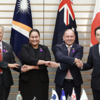 From left: Then-Secretary-General of the Pacific Islands Forum Henry Puna, then-Minister of Foreign Affairs and Trade of the Marshall Islands Kitlang Kabua and Prime Minister of the Cook Islands Mark Brown pose with Prime Minister Fumio Kishida on Feb. 7, 2023, in Tokyo. | JIJI