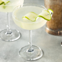 Sake is being enjoyed in unconventional ways, such as in a saketini cocktail garnished with cucumber. | GETTY IMAGES