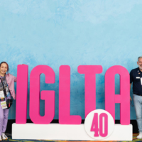 Attendees pose with the IGLTA logo at the group’s convention in Puerto Rico in October 2023. | GHOST EDITS